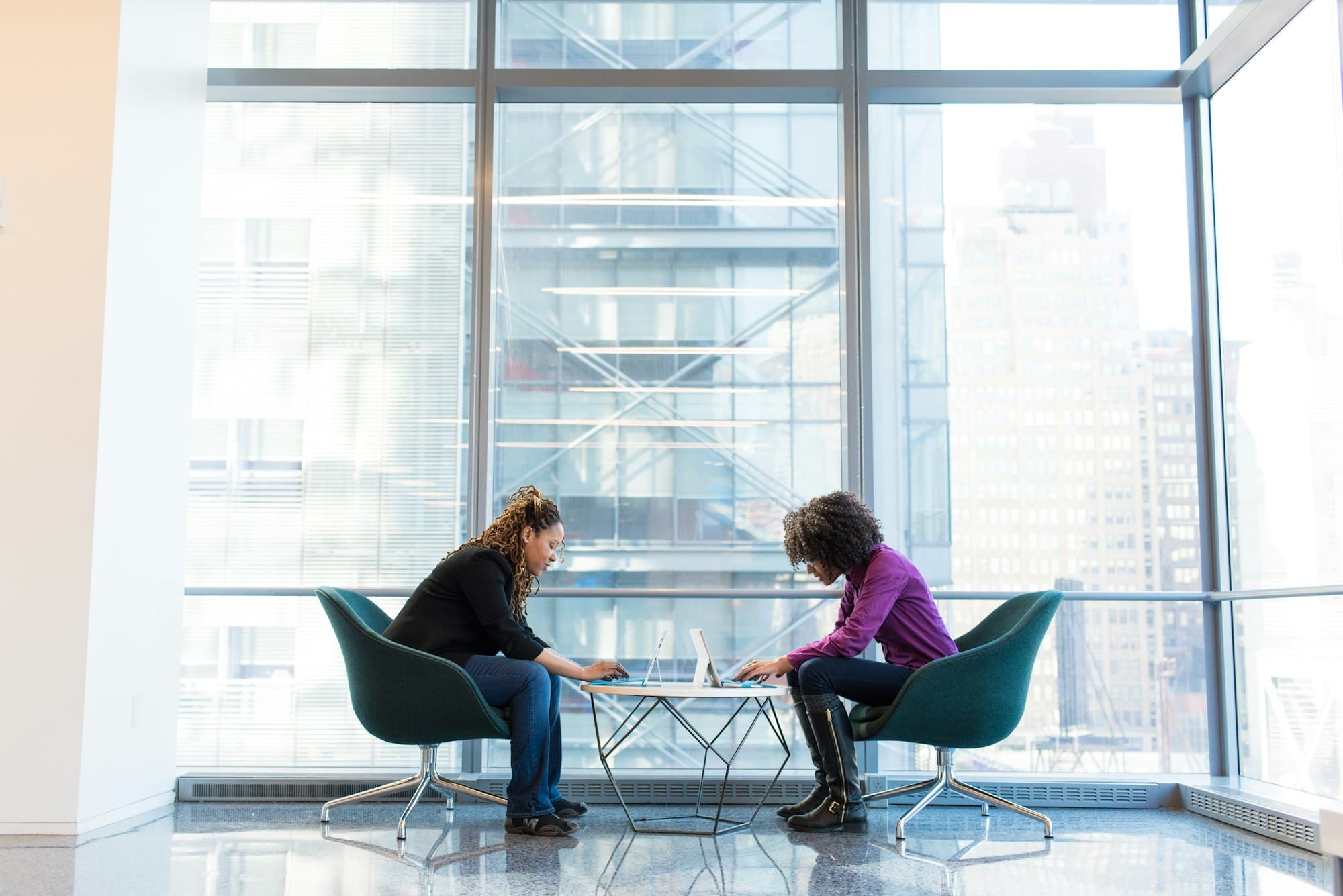 Advisors meeting with a client in a glass-walled office