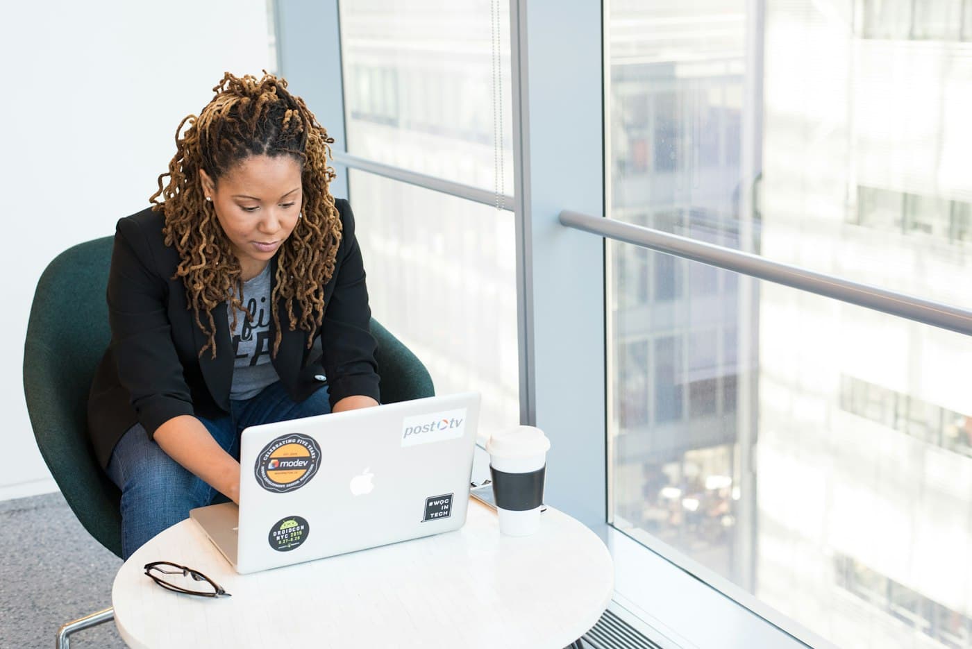 An analyst reviewing work by a window